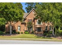 Charming brick home with mature trees in a well-maintained neighborhood at 385 Guildhall Grv, Johns Creek, GA 30022