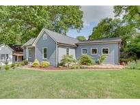 Charming single-story home with manicured lawn and lush landscaping, creating inviting curb appeal at 1143 Church Nw St, Atlanta, GA 30318
