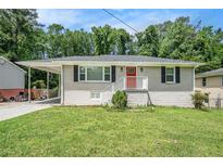Charming single-story home featuring a cozy carport and a well-maintained front yard at 3204 Robin Rd, Decatur, GA 30032