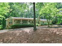 Charming single-story home featuring a welcoming front porch and lush, mature landscaping at 3320 Bryant Ln, Marietta, GA 30066