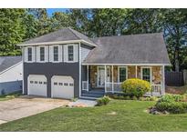 Charming home with a two-car garage, stone accents, and well-manicured lawn at 4865 Fenbrook Dr, Stone Mountain, GA 30088
