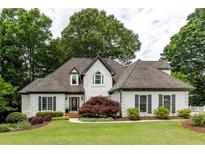 Charming two-story home with a manicured lawn, lush landscaping, and inviting entrance at 285 Lackland Court, Sandy Springs, GA 30350