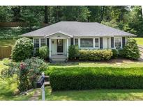 Charming single-story home with a well-manicured lawn, mature trees, and inviting curb appeal at 184 Rambo Sw Pl, Marietta, GA 30064