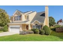 Charming two-story home with a well-manicured lawn and attached two car garage at 2447 Stancrest Ln, Lawrenceville, GA 30044