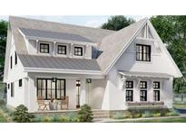 Charming two-story home with white siding, black windows, covered porch and inviting curb appeal at 6821 Phillips Mill Rd, Douglasville, GA 30135
