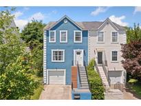Charming two-story home with unique blue siding and inviting staircase entrance at 1857 Barrington Ct, Marietta, GA 30066