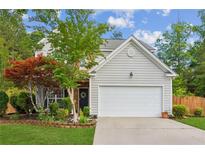 Charming two-story home features a well-maintained lawn, attached two-car garage, and mature landscaping at 2173 Beacon Crest Dr, Buford, GA 30519