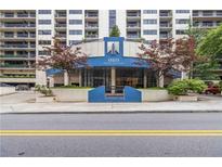 Ansley Above the Park entrance featuring modern architecture with mature trees and manicured landscaping at 1130 Piedmont Ne Ave # 803, Atlanta, GA 30309
