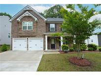 Charming two-story brick home with a well-manicured lawn and two-car garage at 2272 Gateway Trl, Ellenwood, GA 30294