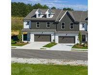 Charming new construction townhomes with attractive exteriors and attached garages, perfect for modern living at 210 Sharon Ln, Loganville, GA 30052