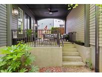 Inviting covered front porch with wrought iron railings and outdoor seating area for relaxing and entertaining at 262 Southerland Ne Ter, Atlanta, GA 30307