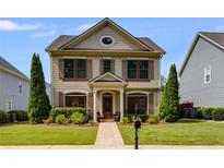 Charming two-story home featuring a well-manicured lawn and craftsman-style architectural details at 4619 Sweetwater Ave, Powder Springs, GA 30127
