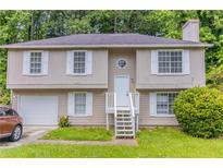 Charming home featuring a neutral exterior with a well-maintained front yard and bright white trim at 5339 Biffle Downs Rd, Stone Mountain, GA 30088