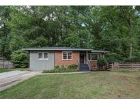 Charming single-story home with a brick facade, neutral siding, and a well-maintained lawn at 1140 Allgood Rd, Stone Mountain, GA 30083