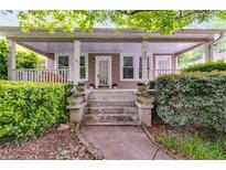 Charming front porch with swing, potted plants, and inviting curb appeal at 959 Hall Nw Pl, Atlanta, GA 30318