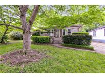 Charming home with a front porch, mature shade tree, walkway, and lush landscaping at 959 Hall Nw Pl, Atlanta, GA 30318