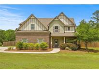 Charming two-story home featuring brick and siding accents, a well-manicured lawn, and a welcoming front porch at 237 Arborview Dr, Mcdonough, GA 30252