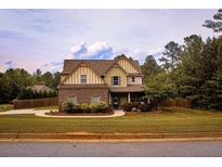 Charming two-story home with manicured lawn and welcoming front entrance at 237 Arborview Dr, Mcdonough, GA 30252