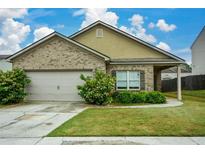 Charming one-story home with a well-maintained lawn, brick facade, and attached two-car garage at 2671 Calvary Dr, Hampton, GA 30228