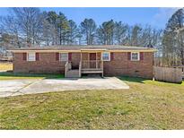 Charming single-story brick home featuring a well-manicured lawn and a cozy front porch at 2968 Cleburne Pkwy, Powder Springs, GA 30127