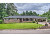 Charming brick home featuring a well-maintained lawn and inviting curb appeal at 5478 Janice Ln, Stone Mountain, GA 30087