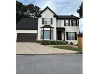 Charming two-story home with a well-maintained front yard and attached two-car garage at 1951 Bergerac Sw Ct, Marietta, GA 30008