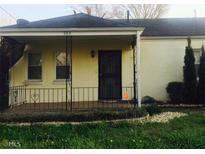 Charming home featuring an enclosed front porch and quaint decorative wrought iron fencing at 264 Taft St, Atlanta, GA 30315