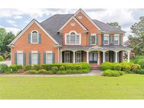 Stately brick home with a manicured lawn and charming curb appeal at 1900 Briergate Dr, Duluth, GA 30097