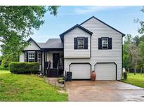 Charming two-story home boasts a well-maintained yard and a two-car garage at 18 Amanda Dr, Dallas, GA 30157