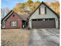 Charming single-Gathering home featuring a brick facade, 2-car garage, and well-maintained front yard at 3335 Ivy Lake Dr, Buford, GA 30519