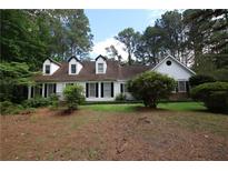 Charming traditional home featuring black shutters, dormer windows, and mature landscaping at , Loganville, GA 30052