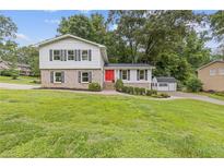 Charming two-story home featuring a bright red front door and well-maintained landscaping at 3751 Cherokee Se Pl, Marietta, GA 30067