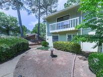 Charming condo with a private entrance, small birdbath, and manicured landscaping at 708 Hanover Se Ln, Marietta, GA 30067