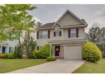 Charming two-story home with a well-maintained lawn, lush bushes, and a welcoming entrance at 6245 Hickory Lane Cir, Union City, GA 30291