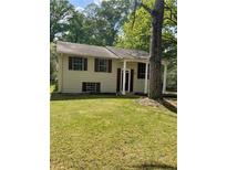 Charming home with a well-maintained lawn and mature trees in a serene and quiet neighborhood at 6399 Boca Grande Blvd, Forest Park, GA 30297