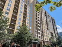 A low angle shot of a luxury building with multiple balconies and beautiful landscaping around the entrance at 1101 Juniper Ne St # 1506, Atlanta, GA 30309
