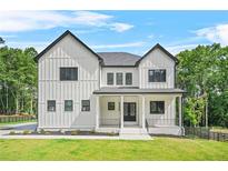Stunning modern farmhouse featuring a manicured lawn and stylish black framed windows at 5175 Cascade Rd, Atlanta, GA 30331