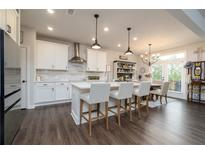 A gourmet kitchen with white cabinets, island with barstool seating, and modern stainless steel appliances at 17 Ridgeline Nw Way, Cartersville, GA 30121