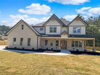 Stunning two-story home with a welcoming front porch and beautiful stone and siding exterior at 1461 Leach Dr, Lawrenceville, GA 30045