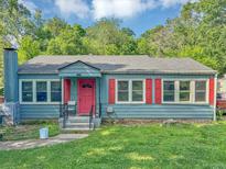Charming blue home with a red door and red shutters on the windows at 2404 Shallowford Ter, Atlanta, GA 30341