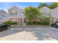 Townhouse complex featuring brick and siding exteriors with ample parking space at 2566 Walden Lake Dr, Decatur, GA 30035