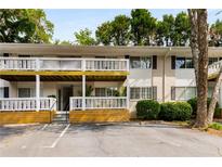 Multi-Gathering home with white siding, a covered balcony, designated parking, and mature trees at 1990 Wellbourne Dr # 5, Atlanta, GA 30324
