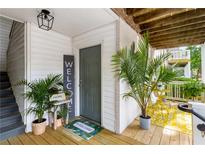Inviting front door area with a welcome mat, plants, and a small table with 'HOME' decor at 1990 Wellbourne Dr # 5, Atlanta, GA 30324