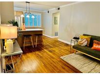 Bright living area with hardwood floors, kitchen bar, and cozy seating at 1990 Wellbourne Dr # 5, Atlanta, GA 30324