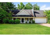 Charming single-story home with a welcoming front porch and well-maintained landscaping at 85 Chestnut Dr, Covington, GA 30016