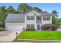 Charming two-story home featuring stone accents, manicured lawn, and an attached two-car garage at 1070 Evergreen Oak Way, Dacula, GA 30019