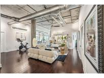 Spacious living room boasts exposed ductwork and concrete pillar, creating an industrial-chic vibe at 206 Ne 11Th Ne St # 703A, Atlanta, GA 30309
