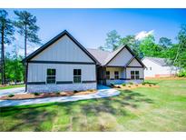 Charming one-story home with gray siding, stone accents, and a well-manicured lawn at 8088 Lakeview Pkwy, Villa Rica, GA 30180