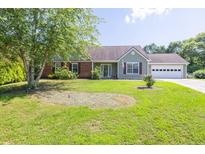 Charming single-story home with a well-manicured lawn and an attached two-car garage at 1490 Twin Manor Dr, Loganville, GA 30052