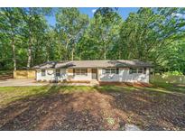 Charming ranch-style home with freshly painted exterior and well-maintained front yard landscaping at 5155 Oakdale Ct, Douglasville, GA 30135